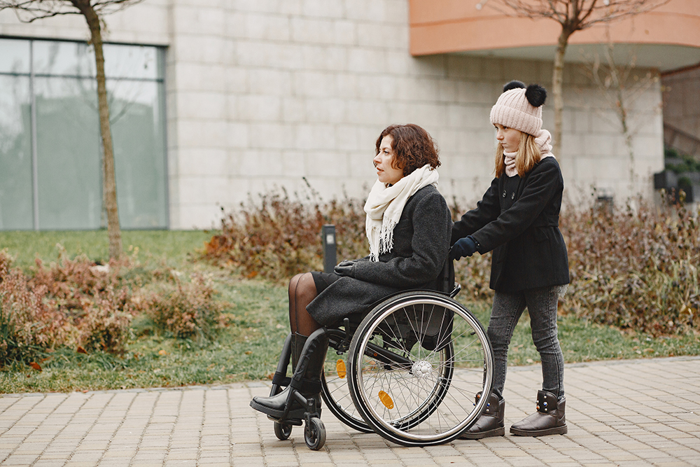Mother in a wheelchair with hre daughter